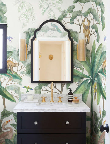 #color::green | Green Jungle Wallpaper Mural used in a powder room with a black mirror and black vanity.