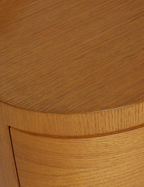 #color::honey-oak | Close up view of the Ripple wavy profile, round two drawer nightstand