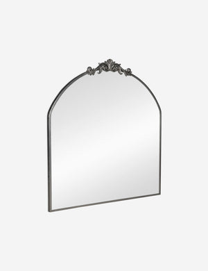 Angled view of the Tulca arched silver mirror with flat bottom edge and traditional scroll detailing.