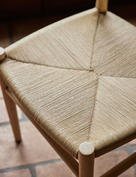 #color::natural-oak | Close up view of the woven seat of the Nicholson slim natural oak wood frame and woven seat dining chair.