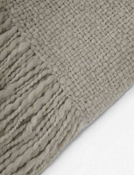 | Close-up of the wool knit details and tasseled ends on the Goleta gray chunky throw blanket