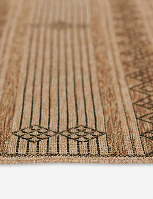 Close-up of the diamond and striped pattern on the Ember brown patterned flatweave indoor and outdoor rug