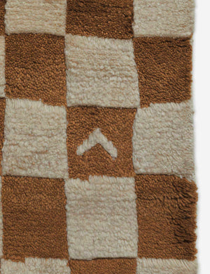 Close-up of the irregular checkerboard pattern on the Irregular ochre checkerboard rug by Sarah Sherman Samuel