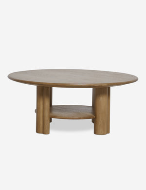 Front view of the Jota round natural oak coffee table with shelf.
