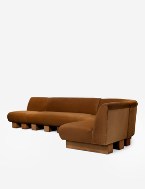 Angled view of the Lena right-facing cognac velvet sectional sofa with upholstered beam legs