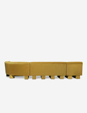 Rear view of the side of the Lena right-facing yellow velvet sectional sofa with upholstered beam legs.