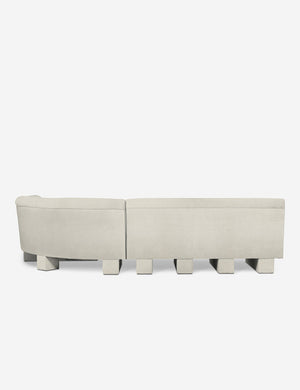 Rear view of the entire Lena left-facing white boucle sectional sofa with upholstered beam legs.