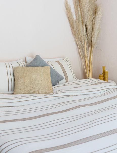 #color::beige #size::queen #size::king | The Marlo Cotton hand loomed beige striped Duvet Set by House No. 23 lays on a bed with natural and gray throw pillows in a bedroom