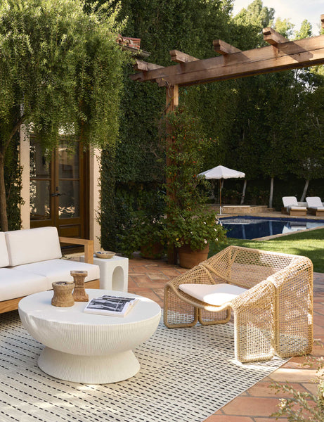 #color::ivory | And outdoor patio space featuring the Dominic round fluted drum outdoor coffee table.