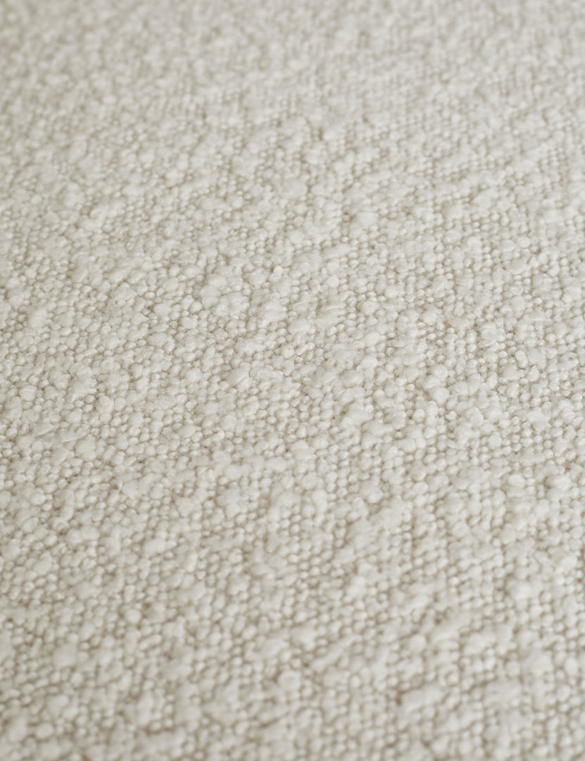 #color::cream | Close-up of the white boucle fabric on the Celeste honey wood accent chair with wishbone frame