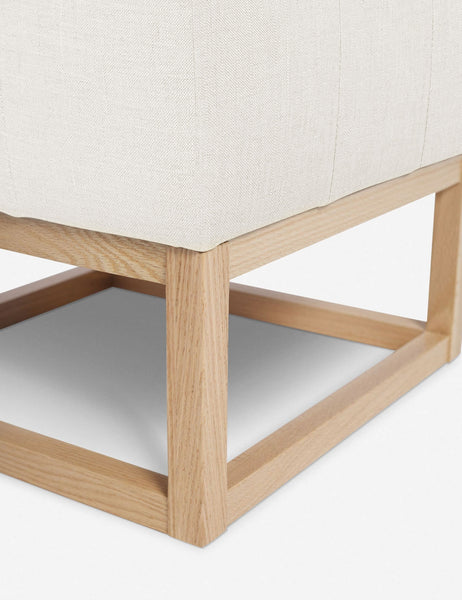 #color::oyster | Close up of the airy wooden frame on the bottom of the Grasmere Oyster White Linen Ottoman