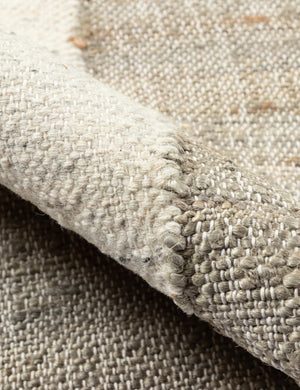 Detailed shot of the handwoven fabric on the Goubi flatweave, neutral toned area Rug by Lemieux et Cie x Momeni