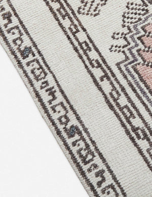 Close-up of the edge of the Zehra hand-knotted ivory, gray and purple medallion wool-blend area rug