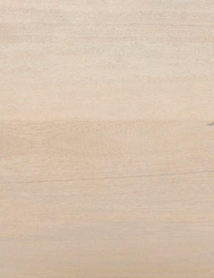 Detailed view of the natural mango wood on the Philene sideboard with cane doors