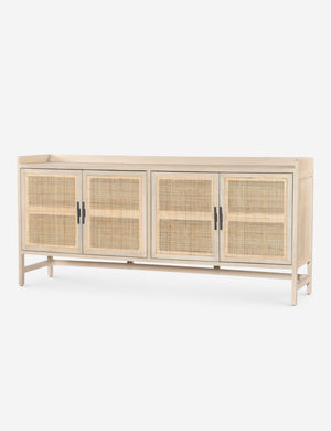 Angled view of the Philene natural mango wood sideboard with cane doors