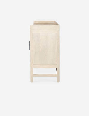 Side view of the Philene natural mango wood sideboard with cane doors