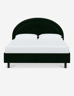 Odele Emerald Green Velvet upholstered bed with an arched headboard that has a welted border