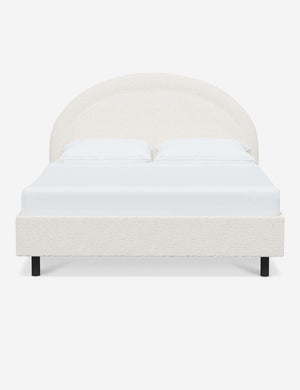 Odele Cream Sherpa upholstered bed with an arched headboard that has a welted border