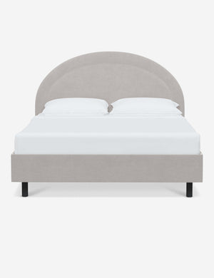 Odele Mineral Gray Velvet upholstered bed with an arched headboard that has a welted border