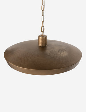 Top of the shade of the Kamlyn shallow hammered metal dome pendant light in brass.