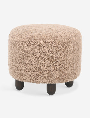 Side view of the Dover faux shearline round ottoman.