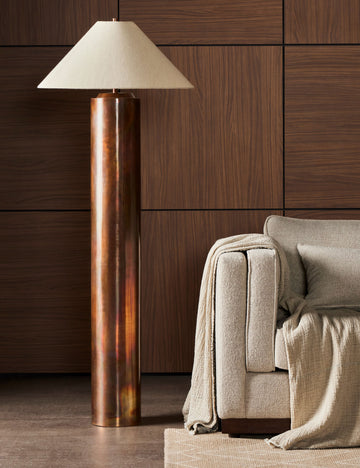 #color::burnt-brass | Sevigne modern burnt brass columnar floor lamp styled next to a sofa.