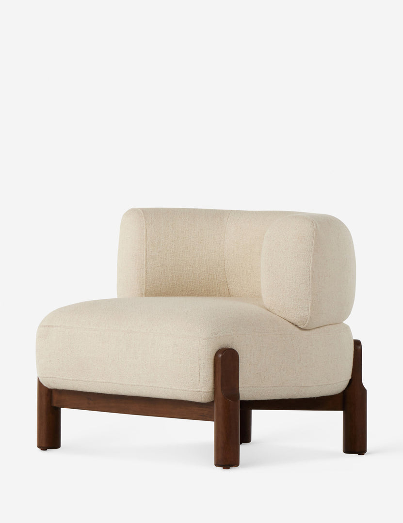 #color::ivory | Angled view of the Furst sculptural upholstered barrel back accent chair in ivory.