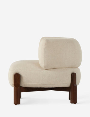 Side view of the Furst sculptural upholstered barrel back accent chair in ivory.