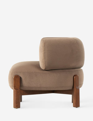 Side view of the Furst sculptural upholstered barrel back accent chair in taupe velvet.