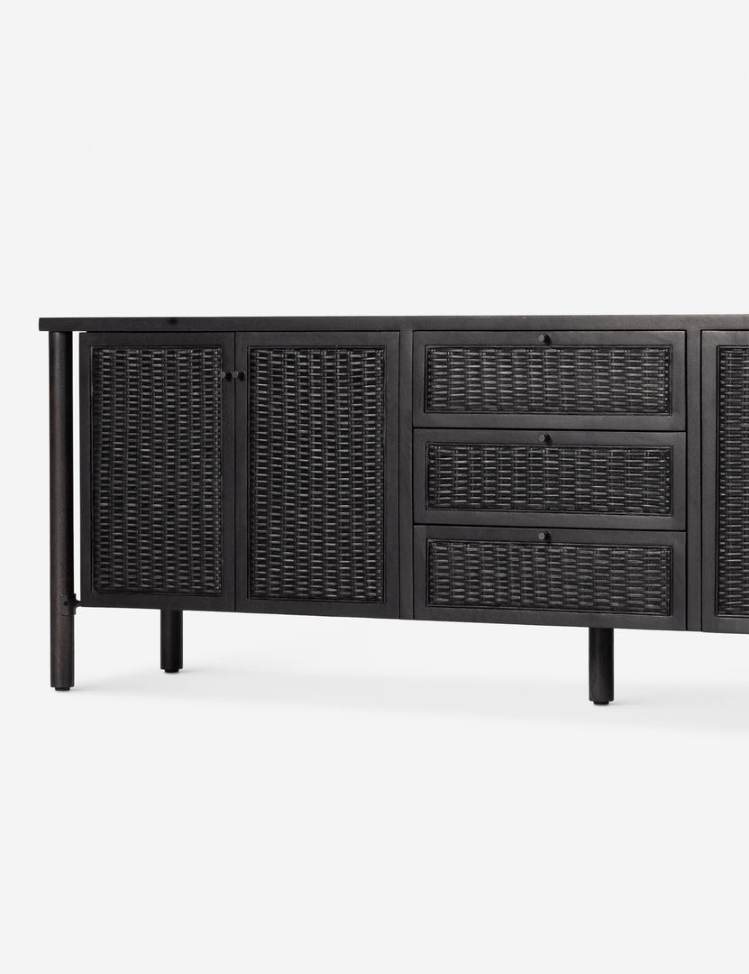 #color::black | Close up view of the Isaura black cane-paneled media console.