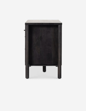 Side view of the Isaura black cane-paneled media console.