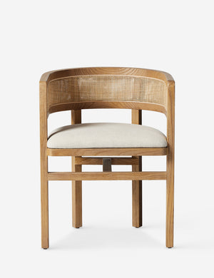Kairi light wood cane barrel back dining chair.