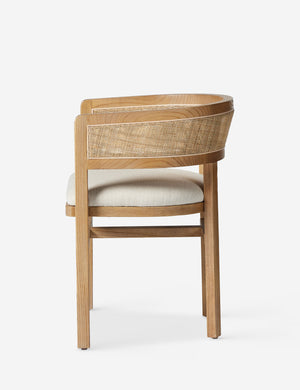 Side profile of the Kairi light wood cane barrel back dining chair.