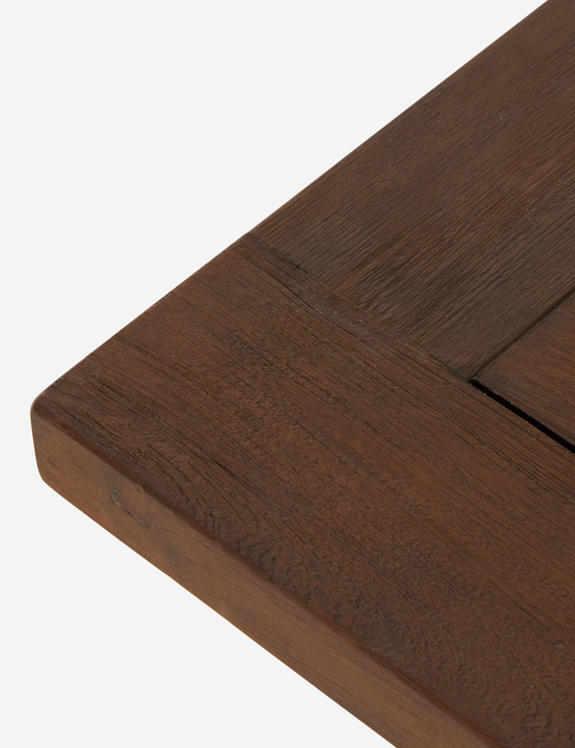 | Close up of the corner of the Kirkman solid teak rustic wood outdoor coffee table.
