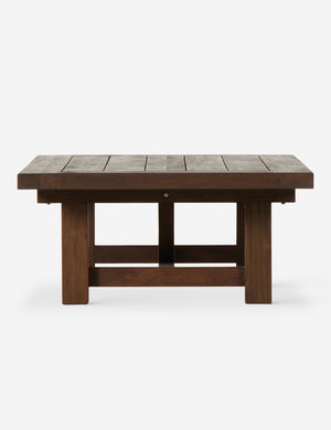 Side view of the Kirkman solid teak rustic wood outdoor coffee table.