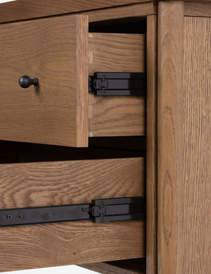 Close up view of the drawers of the Kisner natural grain oak nightstand.
