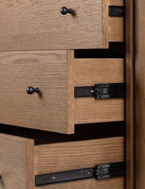 Close up view of the drawers of the Kisner natural grain oak dresser.