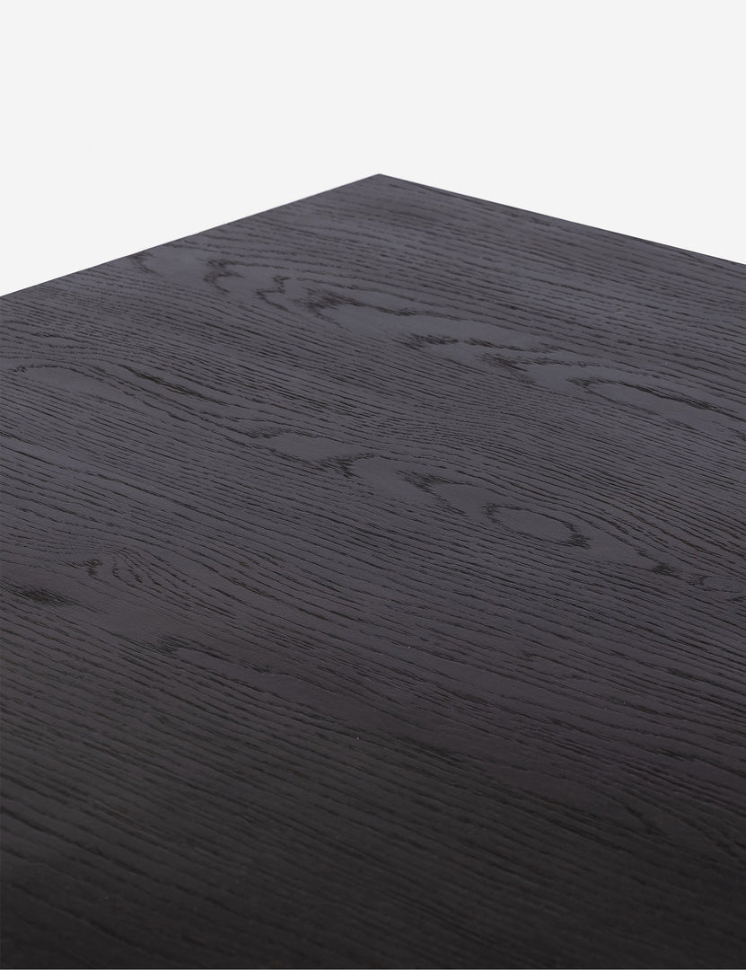 #color::brown | Close up of the Hallen angular leg sculptural dining table.