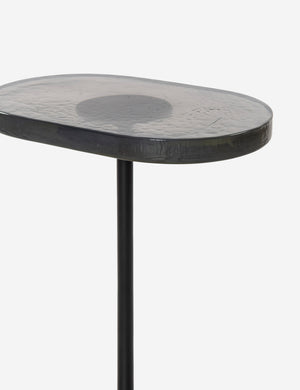 Close up angled view of the top of the Ario slim iron glass top side table.