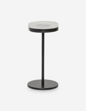 Side view of the Ario slim iron glass top side table.