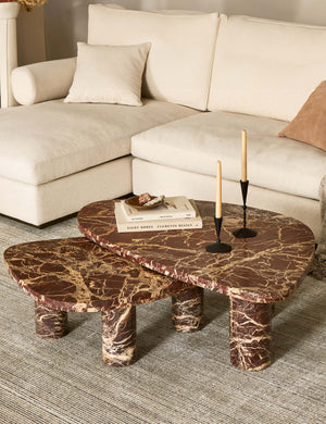 Mariano polished red marble nesting coffee table styled with a striped rug and ivory chaise sectional sofa.