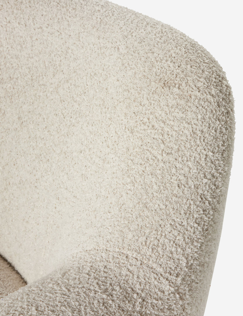 #color::ivory-boucle | Close up view of the fabric texture of the Selkie modern barrel swivel chair in ivory boucle.