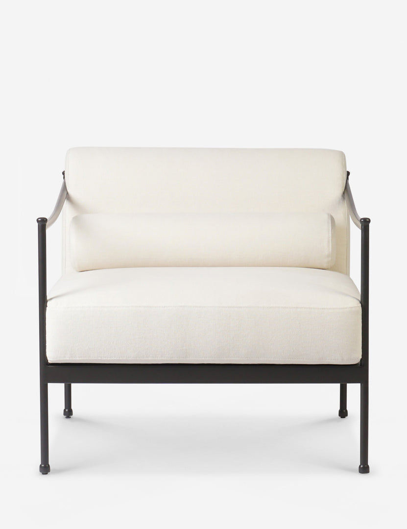 Close-up of the chair's beige textured fabric upholstery and rounded back cushion with matching bolster.