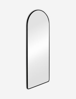 Angled view of the Shashenka black arched floor mirror