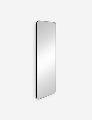 Angled view of the Aire rounded corner leaning floor mirror with black frame