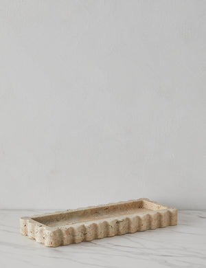 Angled view of the 512 long scalloped decorative tray in travertine