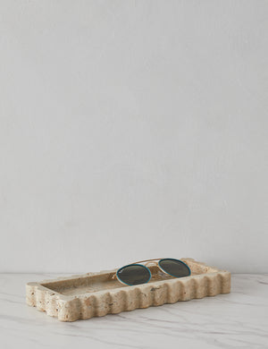 512 long scalloped decorative tray in travertine holding sunglasses