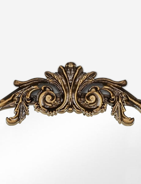 #color::gold | Detailed view of the traditional scroll detailing on the top of the Tulca arched gold mirror with flat bottom edge.