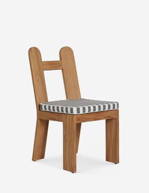 Angled view of the Abbot solid teak sculptural outdoor dining chair by Sarah Sherman Samuel.