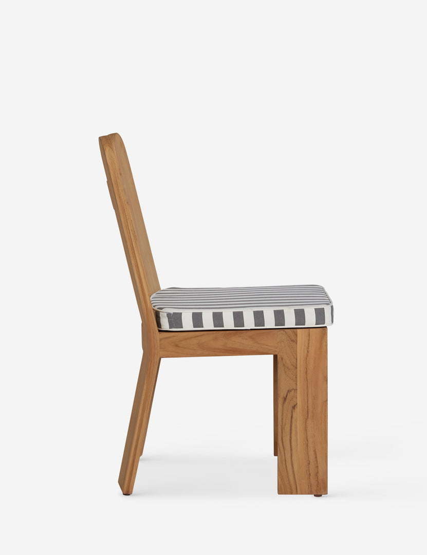 #color::natural-teak | Side profile of the Abbot solid teak sculptural outdoor dining chair by Sarah Sherman Samuel.